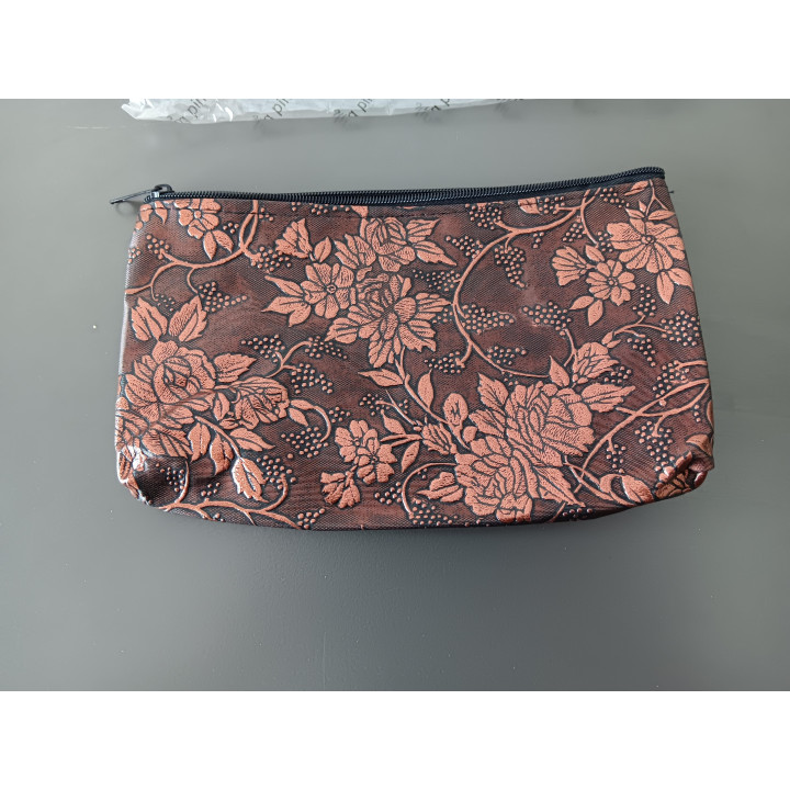 Make-uptasje koperkleur met bloemmotief