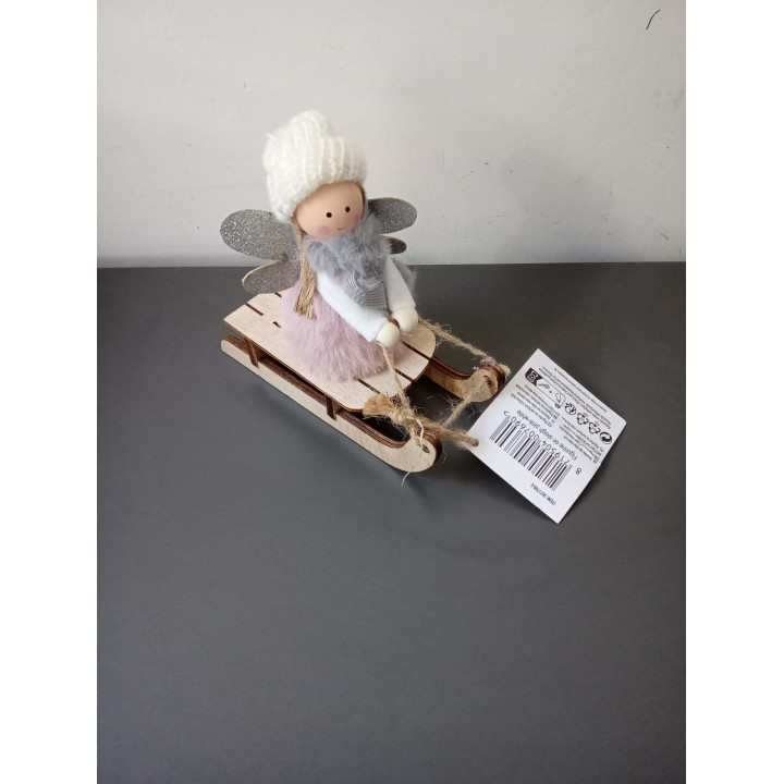 Decoratief meisje op houten slee met gebreide muts